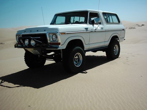 1978 Ford Bronco - This white 1978 Ford Bronco is equipped with an aftermarket bumper and lights, ready for off-road adventures in the sand dunes.