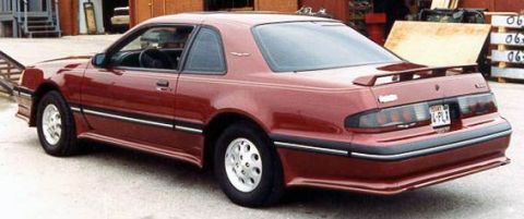 1973 Ford Ranchero - This maroon Ford Thunderbird is shown from the rear quarter angle, a spoiler and distinctive wheels.