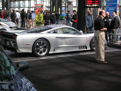 2000 Pontiac Trans Am - A silver Saleen S7 sports car is displayed at an auto show with spectators in the background.