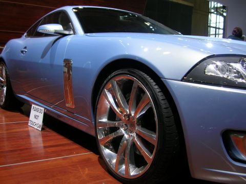 2000 Pontiac Trans Am - A light blue coupe is displayed indoors on a wooden floor, with a sign warning not to touch it.