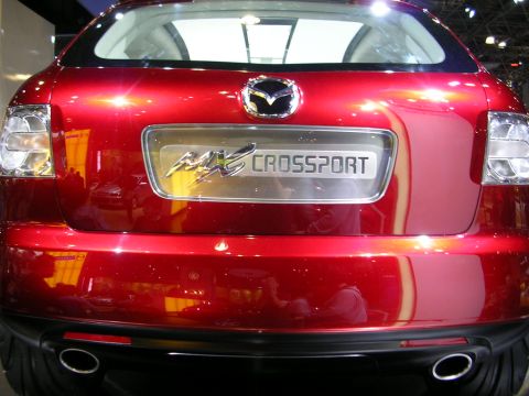 2000 Pontiac Trans Am - The rear of a red Mazda MX-Crossport is shown, its distinctive taillights and badging.