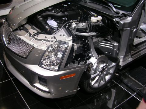 2000 Pontiac Trans Am - A silver car's front end is displayed with the hood open, exposing the engine and suspension system.