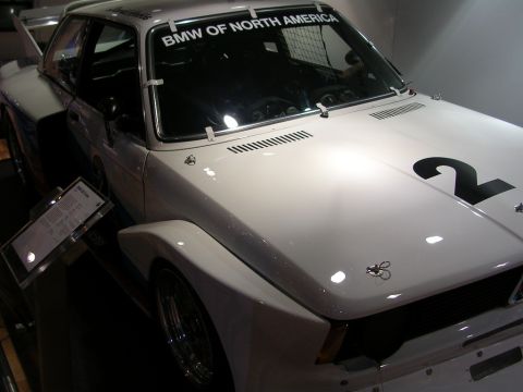 2000 Pontiac Trans Am - A white BMW race car is displayed with a large number 2 on its hood and text on the windshield.