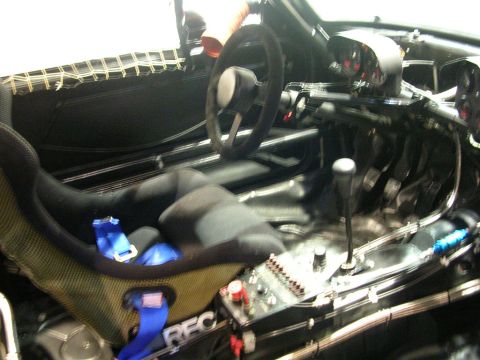 2000 Pontiac Trans Am - The interior of a modified car shows a racing seat, steering wheel, and shifter, suggesting a performance-oriented build.