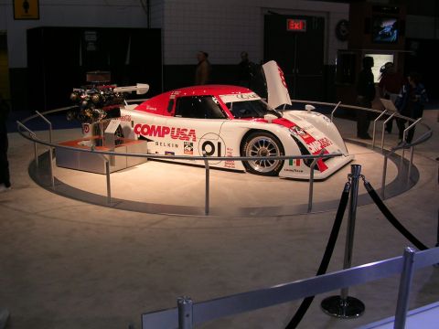 2000 Pontiac Trans Am - A white and red race car, possibly a prototype or concept, is displayed with its engine exposed.