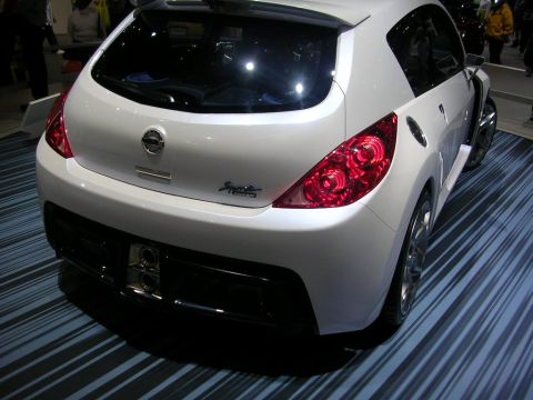 2000 Pontiac Trans Am - The rear of a white Nissan Sport Concept car is displayed on a striped blue and black floor at an auto show.