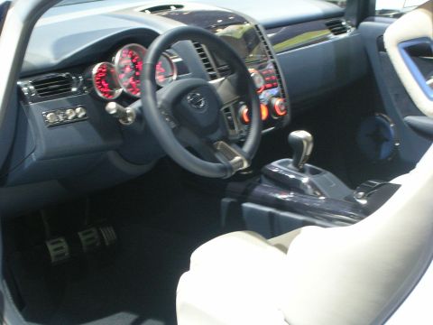 2000 Pontiac Trans Am - Interior view of a car with a prominent dashboard and seating, a "SUPERMOTORS" logo.