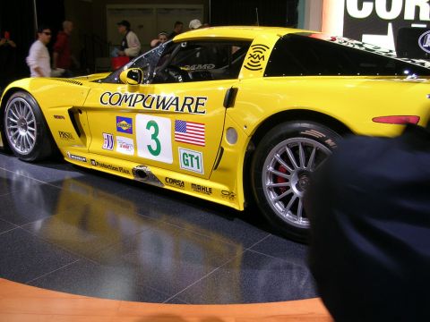2000 Pontiac Trans Am - Yellow race car with 'COMPUWARE' and '3' decals is displayed indoors.