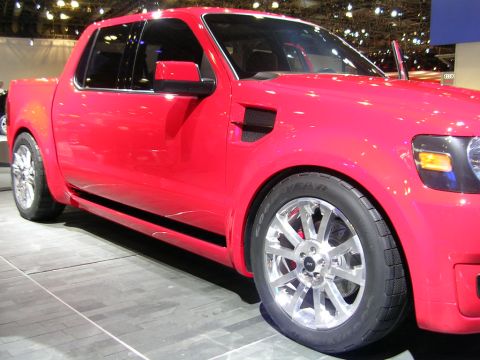 2000 Pontiac Trans Am - A red pickup truck is displayed indoors with its front passenger side visible.