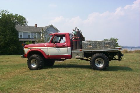 1978 Ford F-250 - This flatbed truck, equipped for welding, is parked on a grassy area with a house in the background.