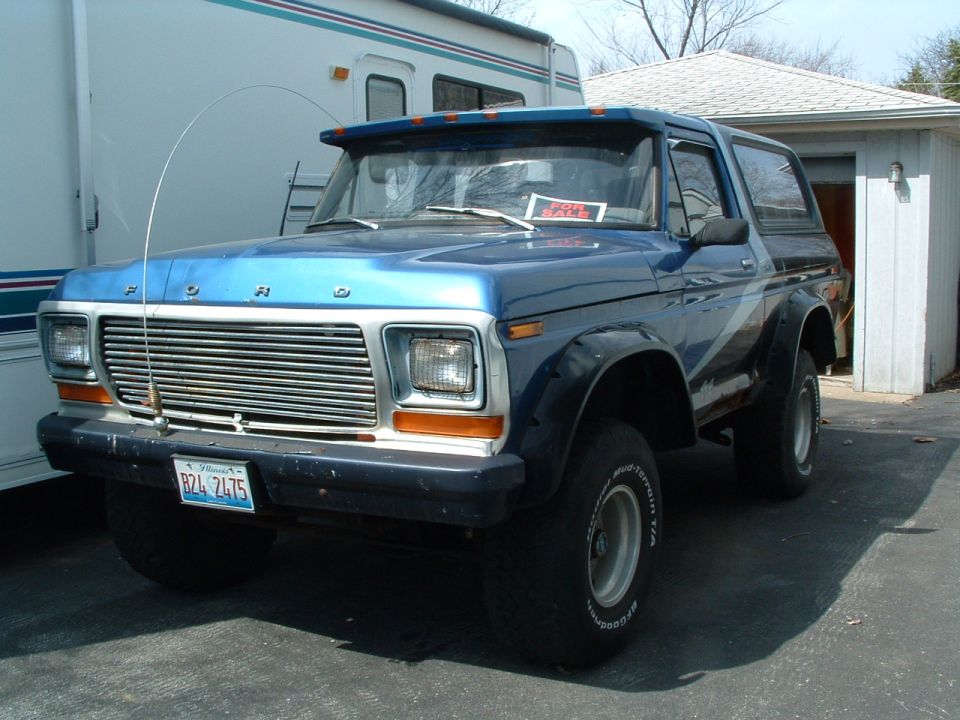 Blue 1979 Ford Bronco with "FOR SALE" sign in window