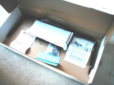 2002 Ford Excursion - New suspension components and paperwork are laid out inside a cardboard box.