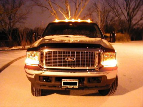 2002 Ford Excursion - Front view of a 2002 Ford Excursion parked in the snow at night.