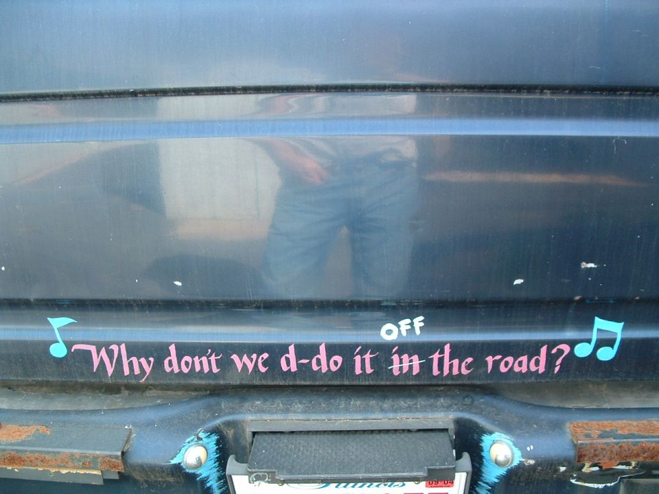 Dark blue tailgate with painted lyric "Why don't we d-do it off the road?" and music notes