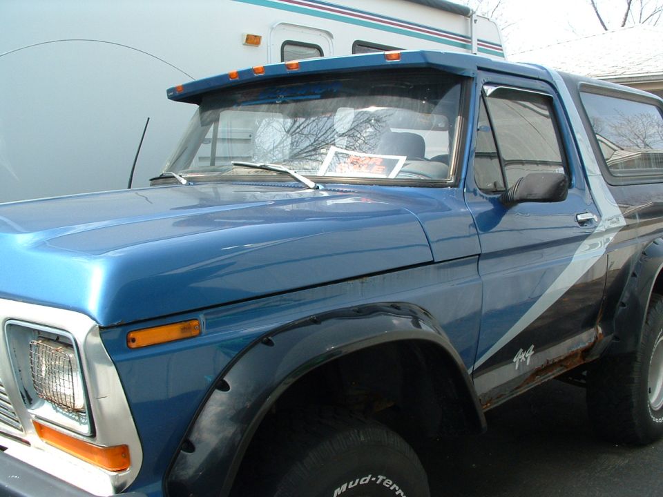 Blue 1979 Ford Bronco with 4x4 decal and rust spots