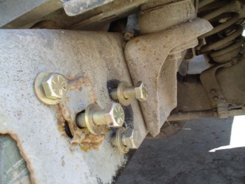 1981 Ford Bronco - drilled one hole, then put the bolt in and tightened it up, aligned the peice with the frame, then took a 2lb hammer and tapped on the othe…