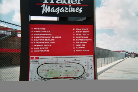 1990 Ford Bronco - Photograph of a racetrack venue directory sign and facility map, not a technical document.