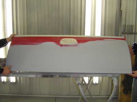 1978 Ford Bronco - A tailgate is being worked on, with red primer visible and a cutout for a light.