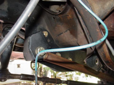 1986 Ford Bronco - Underside view of a vehicle's suspension component, likely a bracket or mount.