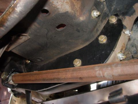 1986 Ford Bronco - Undercarriage view of a vehicle, focusing on a suspension component and mounting hardware.