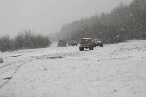 2003 Jeep TJ - Off-road vehicles navigate a snowy landscape during a winter outing.