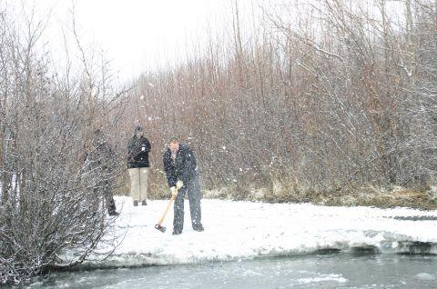 2003 Jeep TJ - People are gathered by a frozen body of water in a snowy environment.