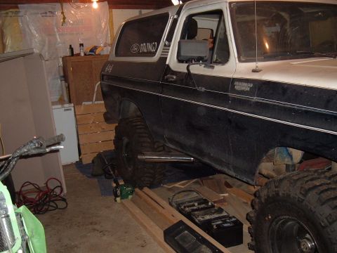 1979 Ford Bronco - This modified Ford Bronco features large off-road tires and side exhaust pipes.