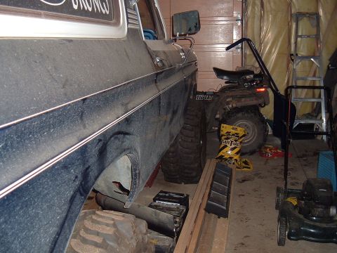1979 Ford Bronco - Side view of a 1979 Ford Bronco parked in a garage with other items.