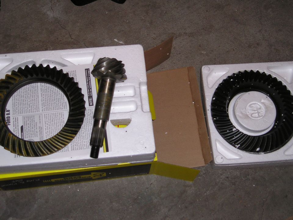 Differential gears in packaging, one ring gear shows "FORD 8.8" text