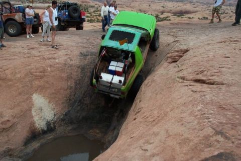 1990 Ford Bronco - This modified off-road vehicle is carefully maneuvered down a steep, narrow rock formation.