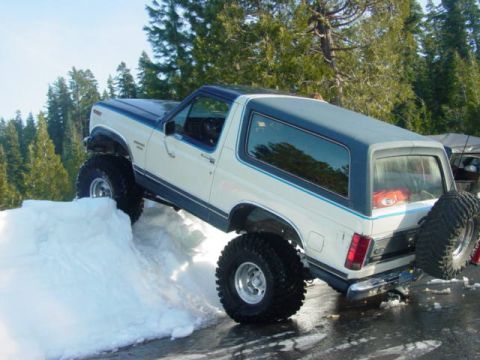 1986 Ford Bronco - This lifted 1986 Ford Bronco is shown navigating a snowy incline.
