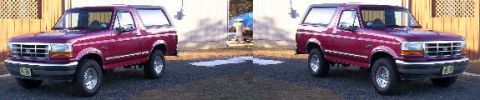 1995 Ford Bronco - This maroon Ford Bronco is parked outside a building with a gravel driveway.