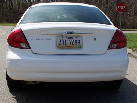 2001 Ford Taurus - Rear view of a white 2001 Ford Taurus sedan, showing the taillights and license plate.