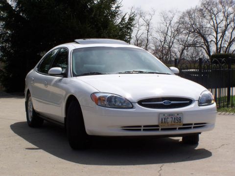 2001 Ford Taurus - A white 2001 Ford Taurus sedan is shown from the front 3/4 angle.