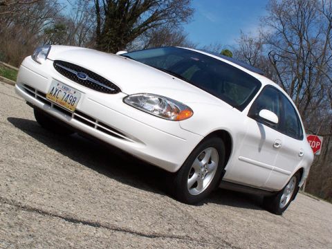2001 Ford Taurus - White 2001 Ford Taurus sedan seen from the front 3/4 angle on a paved road.
