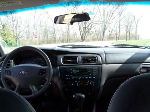 2001 Ford Taurus - The interior of a car is visible from the driver's perspective, looking out through the windshield.