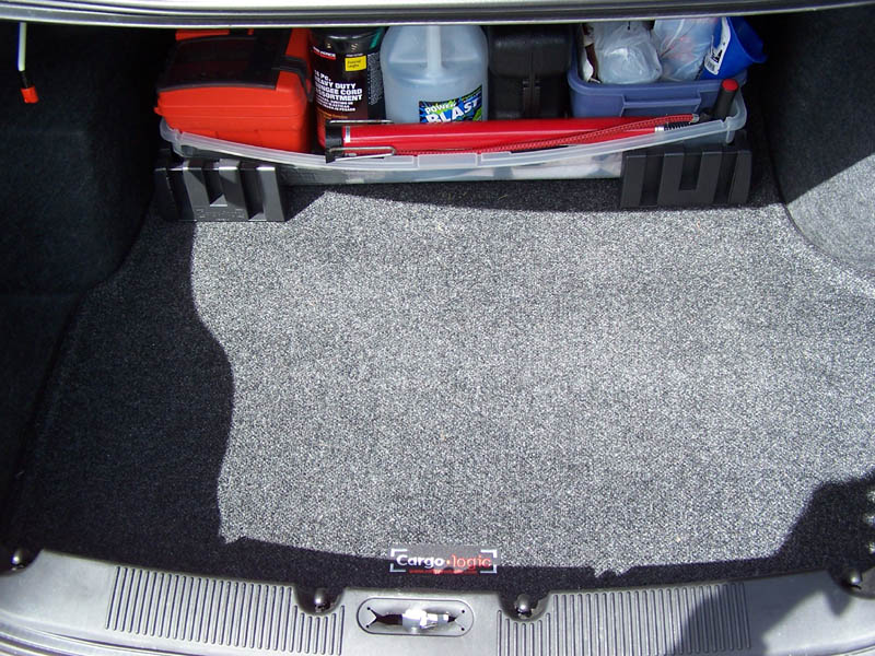 car trunk with a red toolbox, cleaning supplies, and a red emergency flare kit