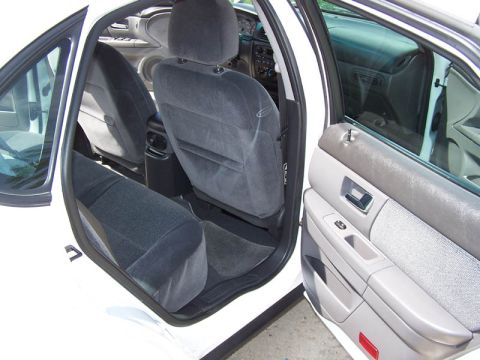 2001 Ford Taurus - Interior view of a 2001 Ford Taurus, showing the front and rear seats and the driver's side door panel.