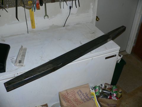1991 Ford Explorer - A metal bar is placed on top of a chest freezer in a workshop setting.