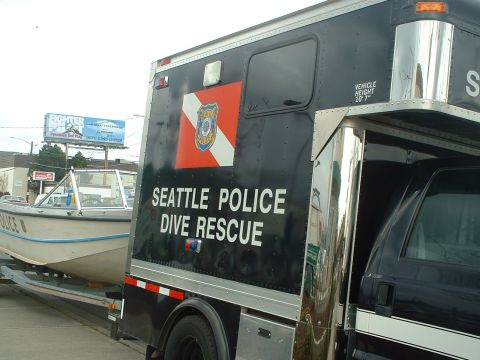 1999 Ford Crown Victoria - A Seattle Police Dive Rescue truck is seen towing a boat on a trailer.