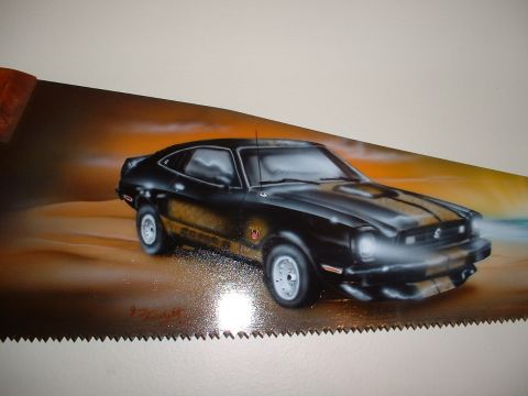 1978 Ford Mustang II - Airbrushed artwork of a classic coupe adorns a saw blade, with a desert-like background.