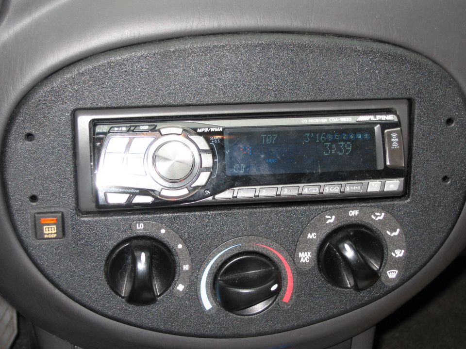Alpine CDA-9833 CD receiver installed in Ford Escort ZX2 dash above HVAC knobs