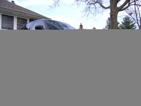 1999 Ford Crown Victoria - This dark sedan, seen from a 3/4 front angle, appears to be a 1999 Ford Crown Victoria based on its body style.