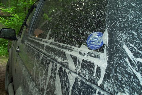 1993 Ford Bronco - Side view of a mud-covered SUV, an FSB sticker on the rear window.