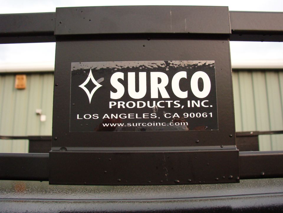 Surco Products decal on black roof rack panel with water beads