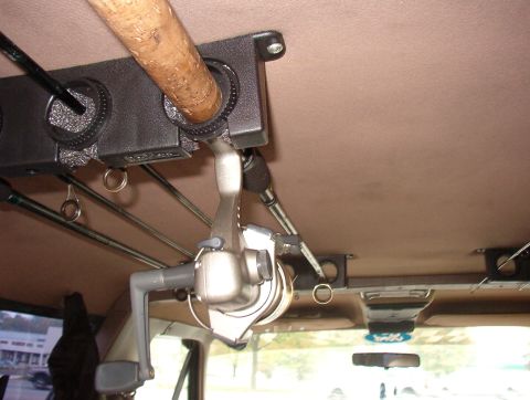 1993 Ford Bronco - Fishing rod holder installed on the interior ceiling of a vehicle.