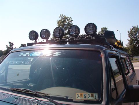 1993 Ford Bronco - 1993 Ford Bronco with KC lights on the roof rack and a checkered decal on the windshield.