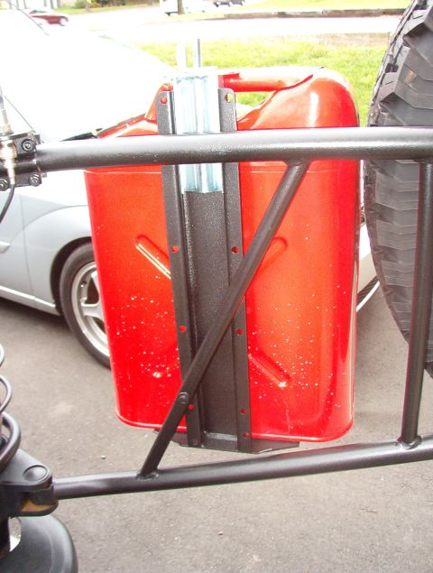 1993 Ford Bronco - Two orange buckets are visible in front of a white car, with part of a metal railing in the foreground.