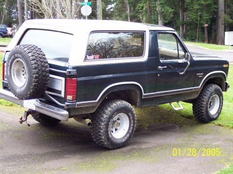 1986 Ford Bronco - This Ford Bronco is shown from a three-quarter front view, a spare tire mounted on the rear.