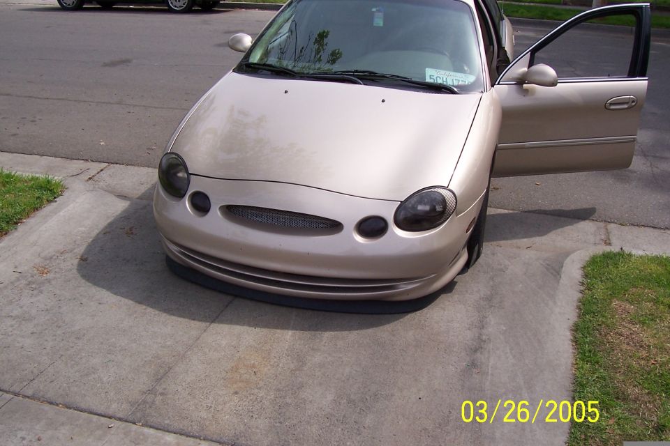 1998 Mercury Sable, tan sedan front 3/4 view with driver door open